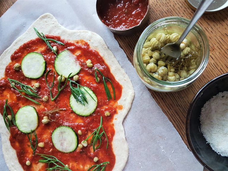 Adding wild toppings before baking the pizza