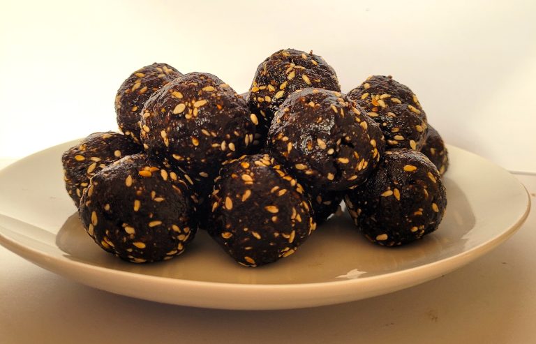 Plate of fresh, homemade bliss balls spiced with magnolia petals