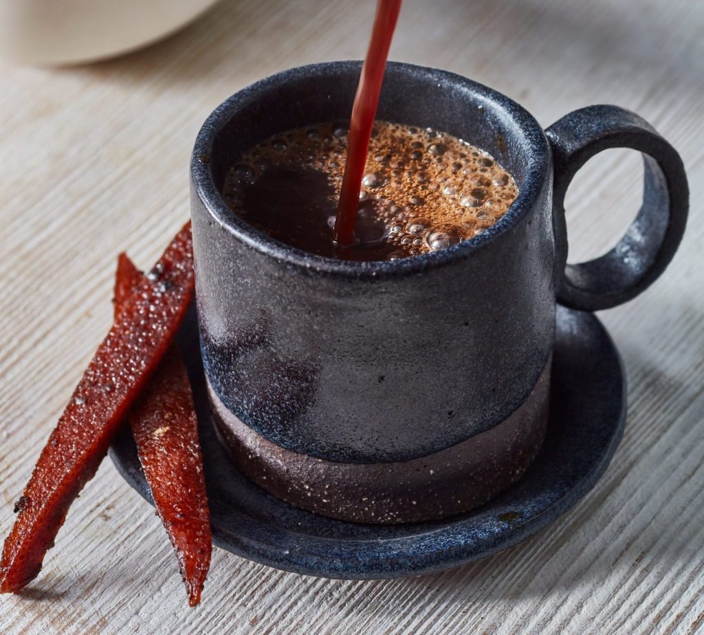 Freshly poured dandelion 'coffee' into a blue expresso cup