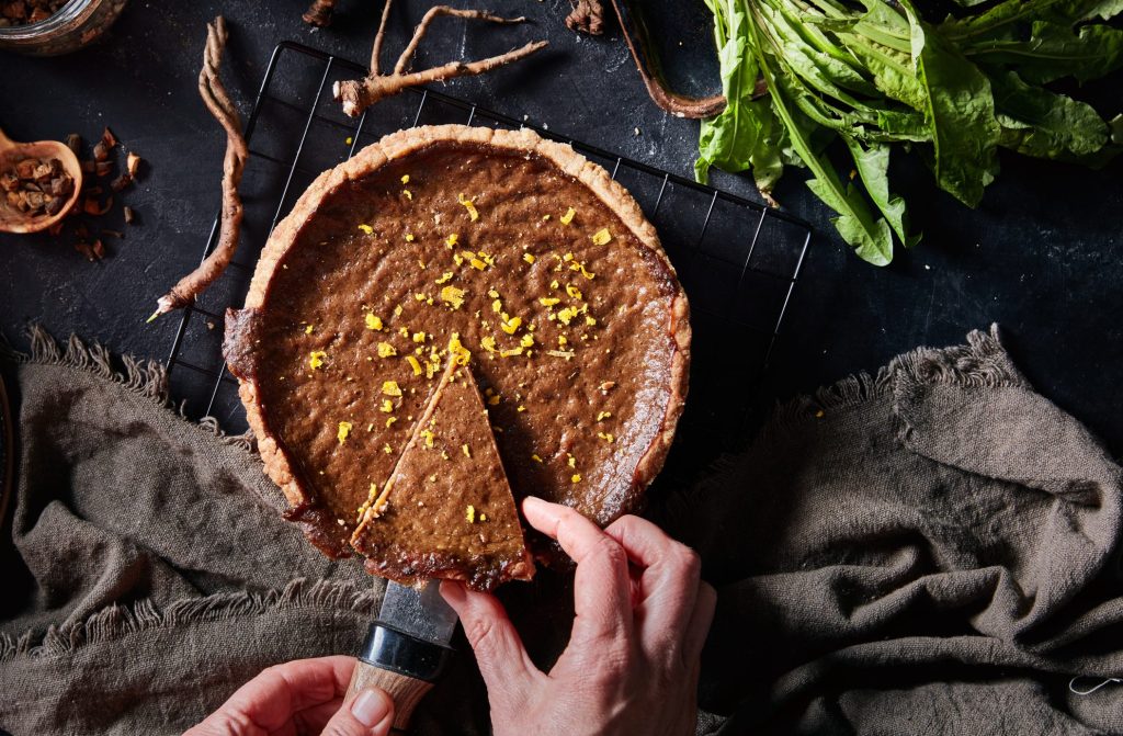 Roasted Dandelion and Orange Pie, aerial few of a slice being cut