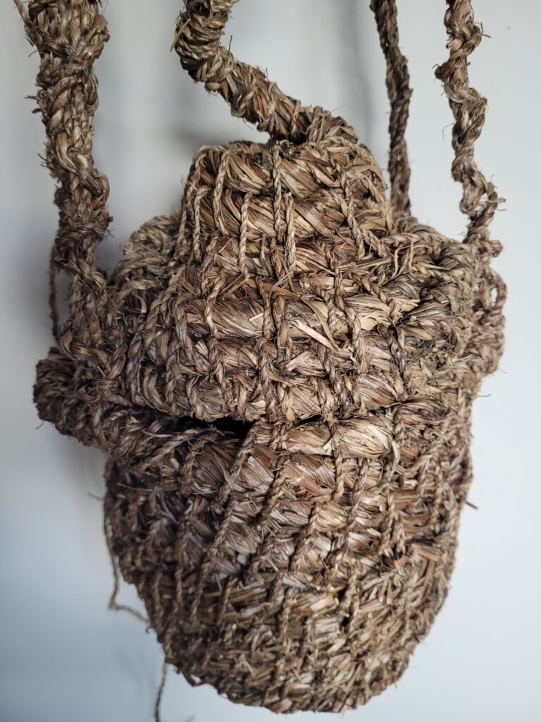 Detail of artisan, handmade pot made from 100% goosegrass, inspired by Catholic essence holder and skeps