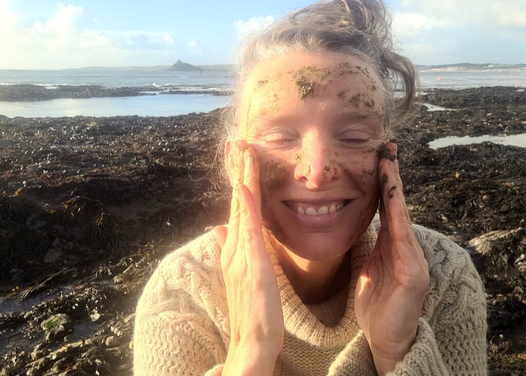Forager Rachel Lambert enjoying a seaweed face mask on the beach