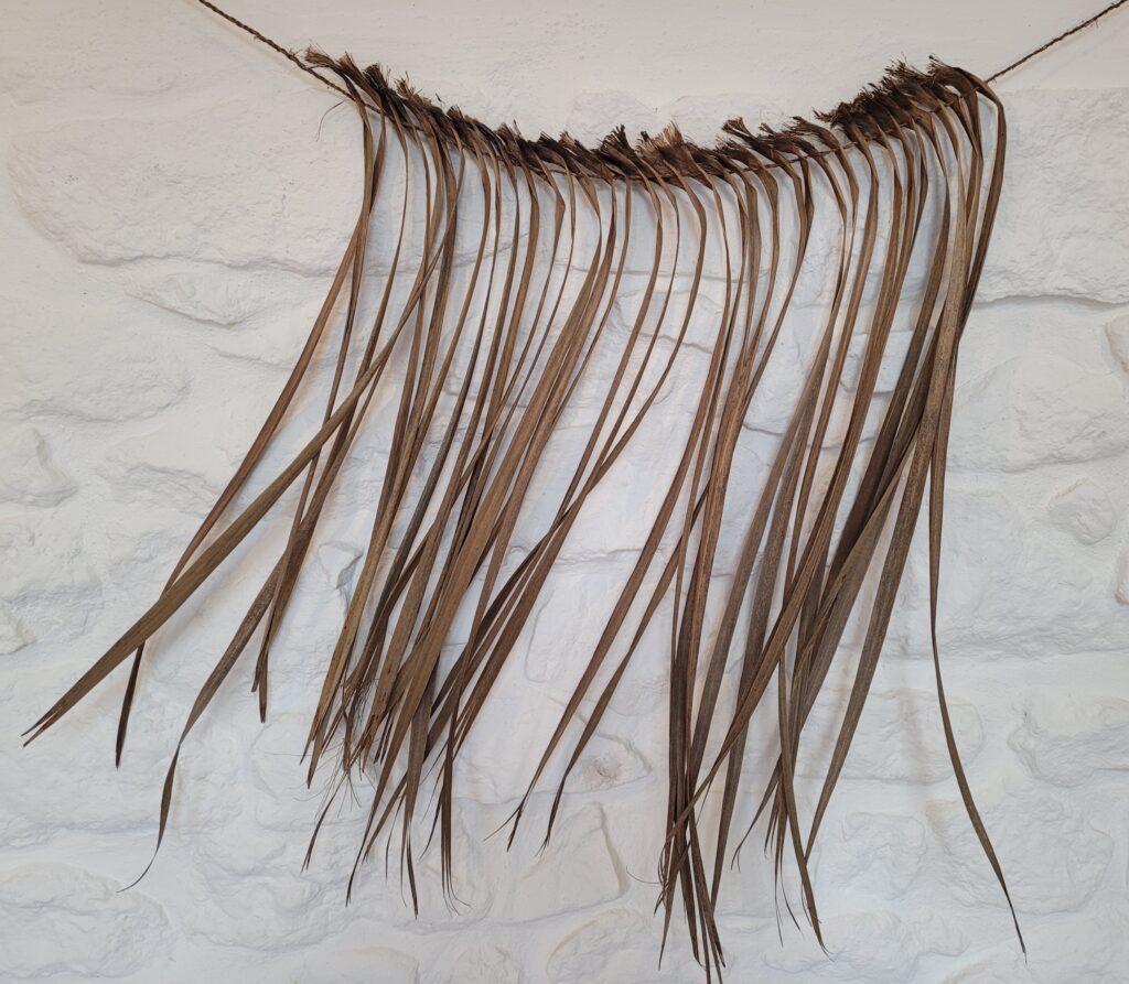 Wall hanging made from Cordyline leaves stitched together with cordage made from the same plants