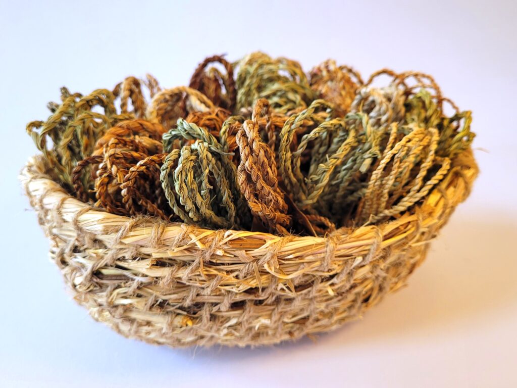 aerial view of basket of 20 bundles of plant strings ranging through greens to browns