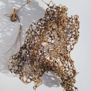 Aerial view of a handmade fishing net made from brown cordyline fibres