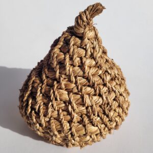 A 3-dimensional object, shaped like a fruit or bulb, woven from dried and golden daffodil stems