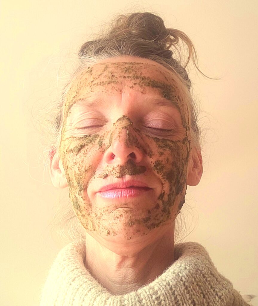 Forager Rachel Lambert closing her eyes with a seaweed face mask on. Head and shoulders shot