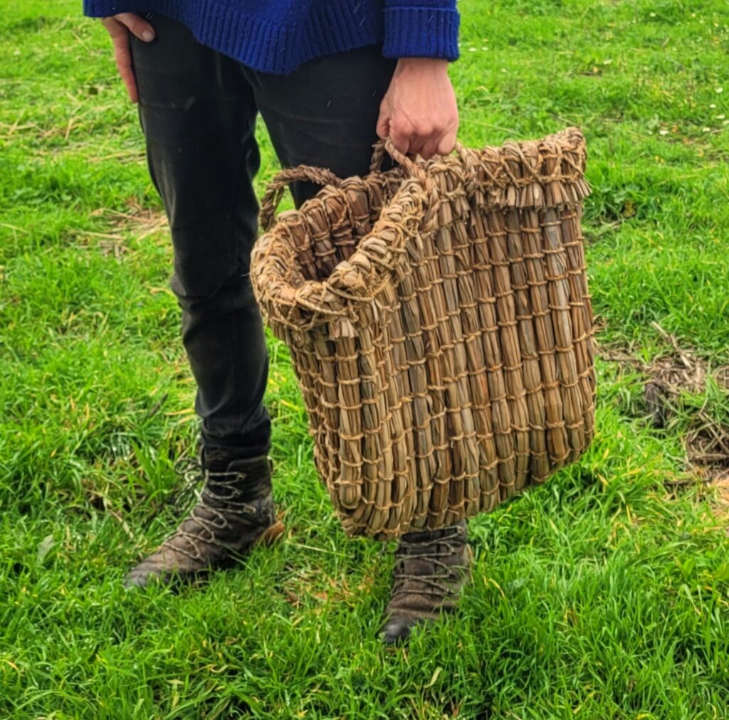 Woman holding a woven basket in her left hand