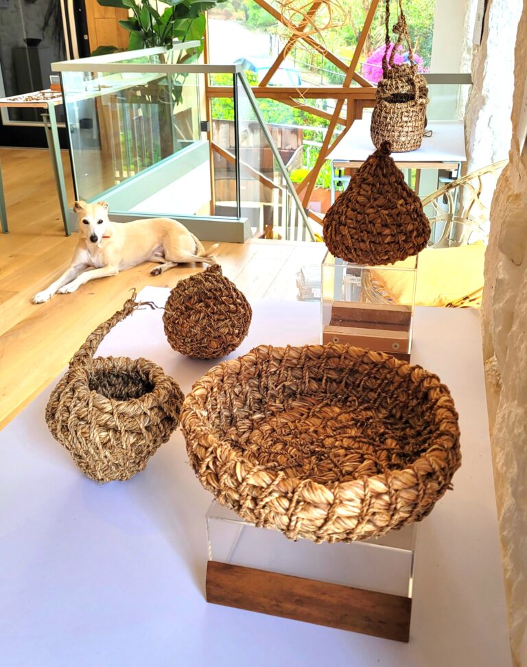 A table of artisan objects made from 100% daffodil stems and leaves