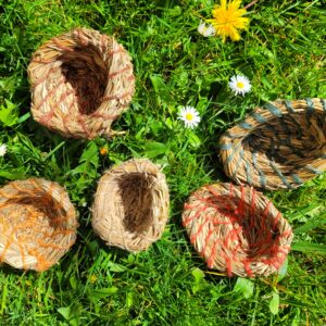 aerial view of 5 pots made from summer grasses and coloured jute string