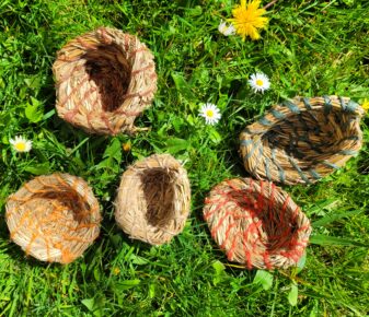 aerial view of 5 pots made from summer grasses and coloured jute string