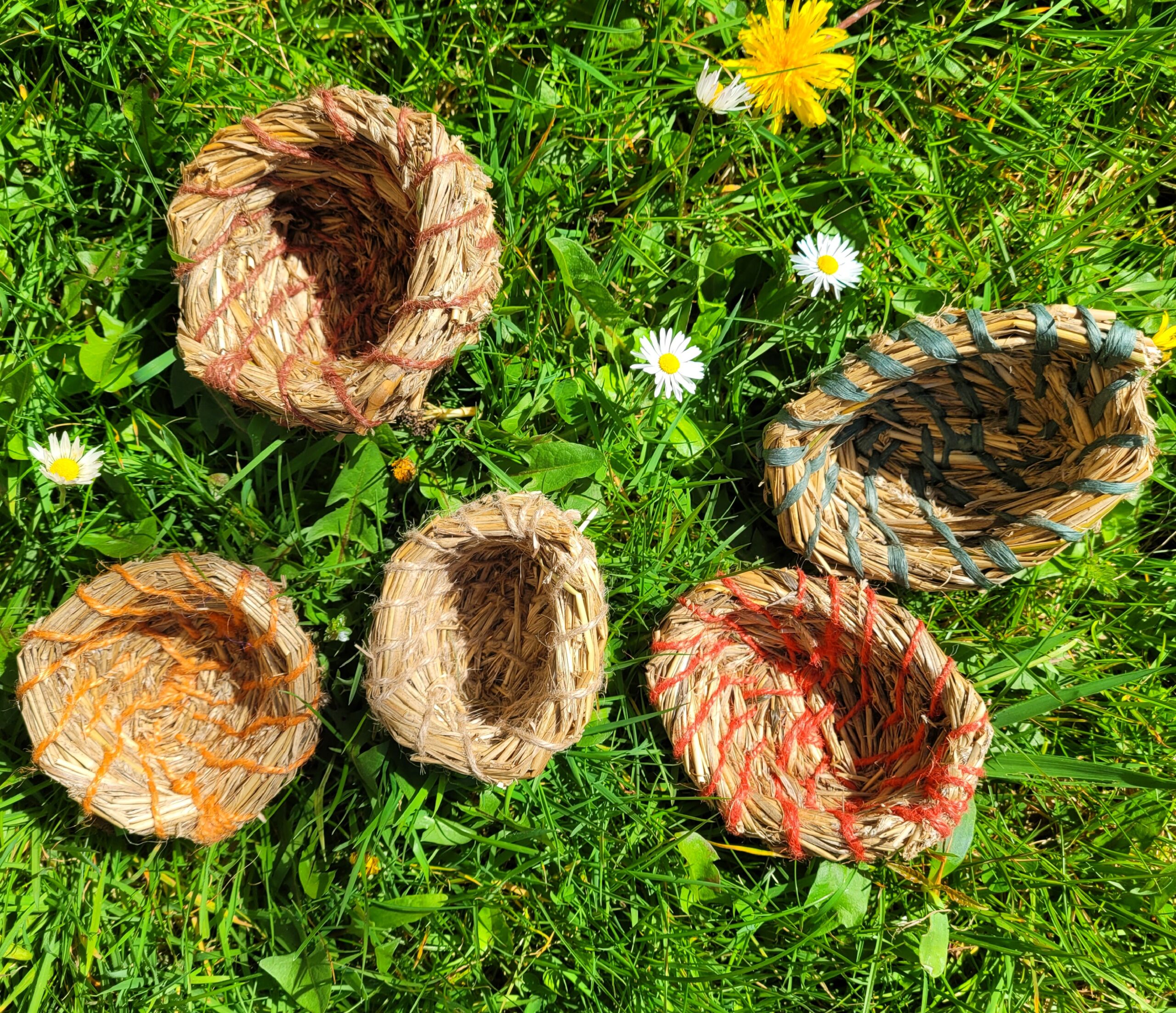 aerial view of 5 pots made from summer grasses and coloured jute string