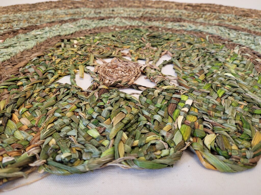 Details of a mat made from a 9-ply plait of green and golden daffodils and sedges