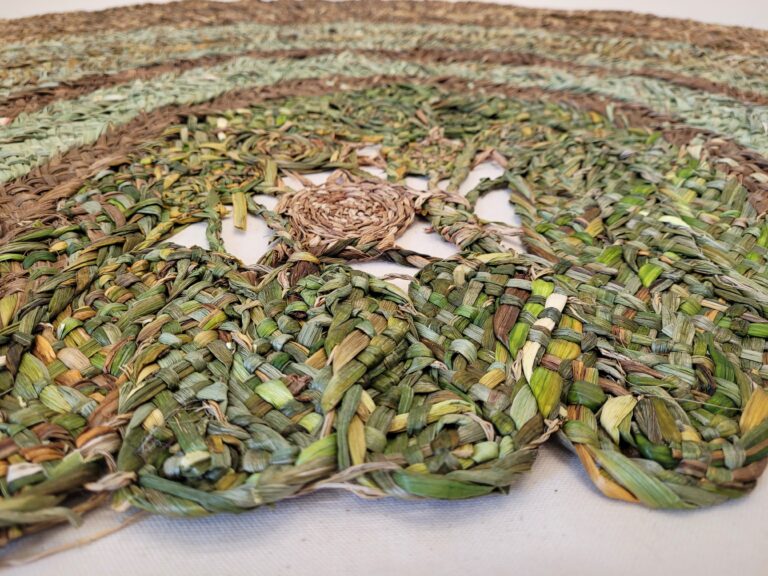 Details of a mat made from a 9-ply plait of green and golden daffodils and sedges